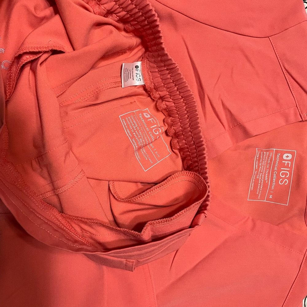 Pink colored, figs scrubs top is medium Catarina and bottom small petite yolas